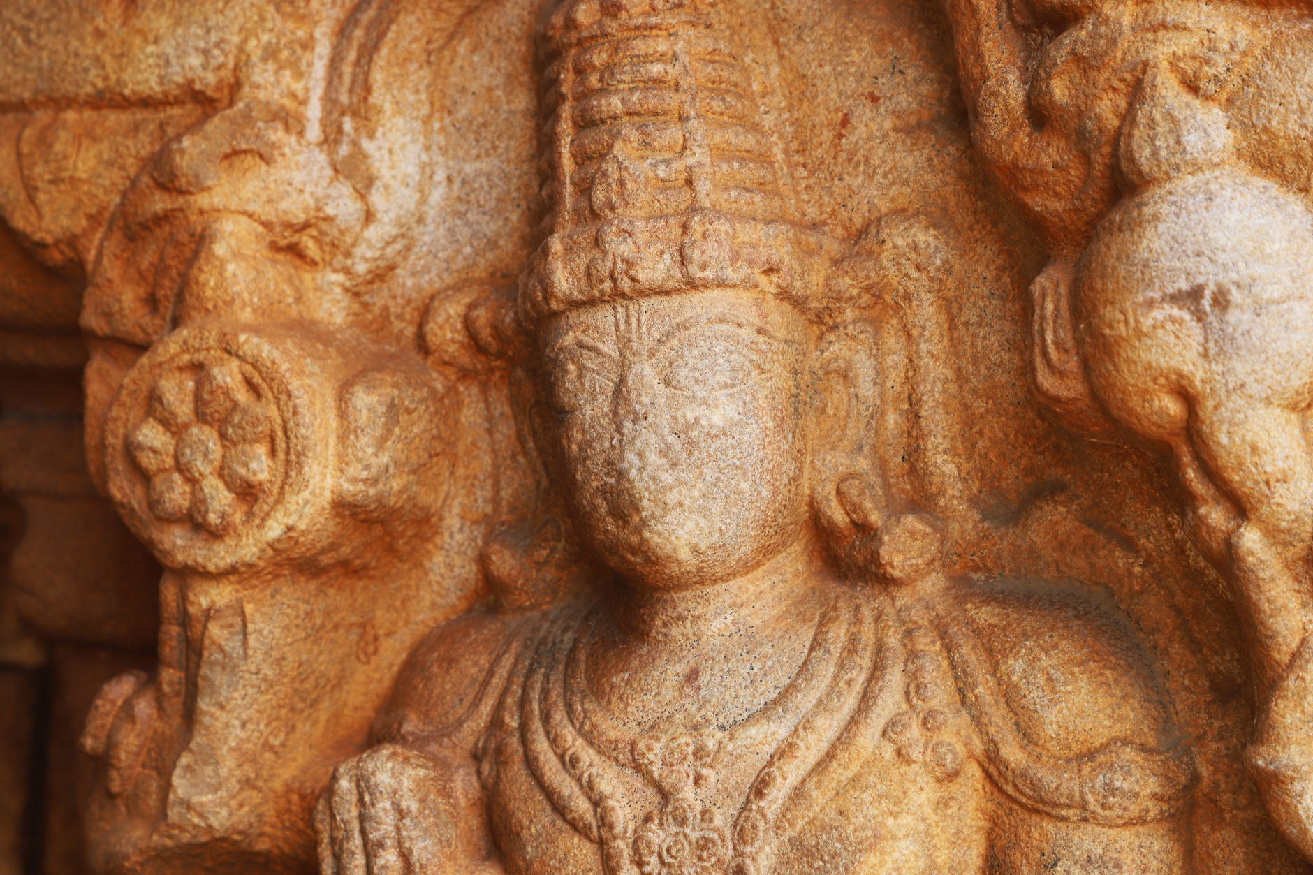 Detailed stone relief of a Hindu deity, showcasing intricate ancient craftsmanship.