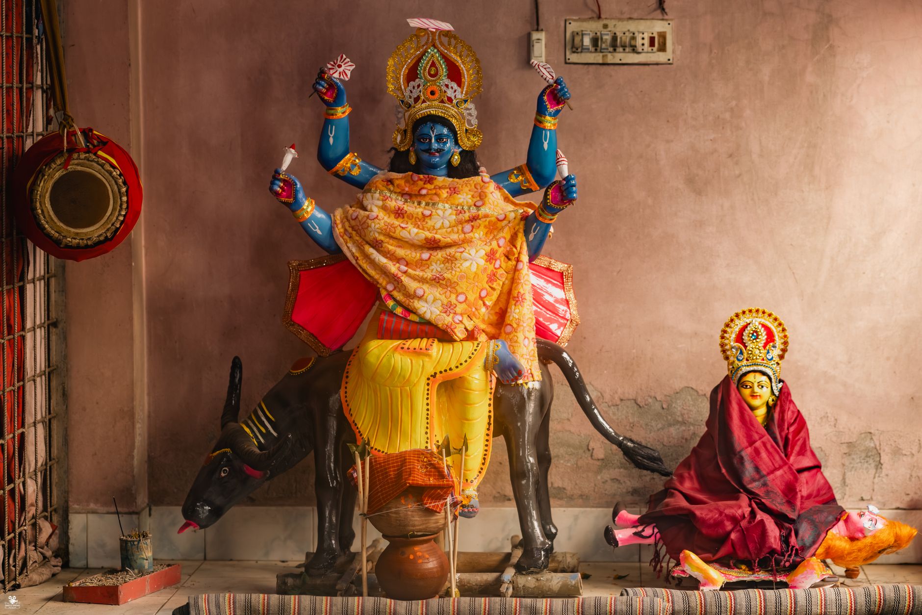 Colorful statue of Hindu goddess Kali displayed in temple setting.