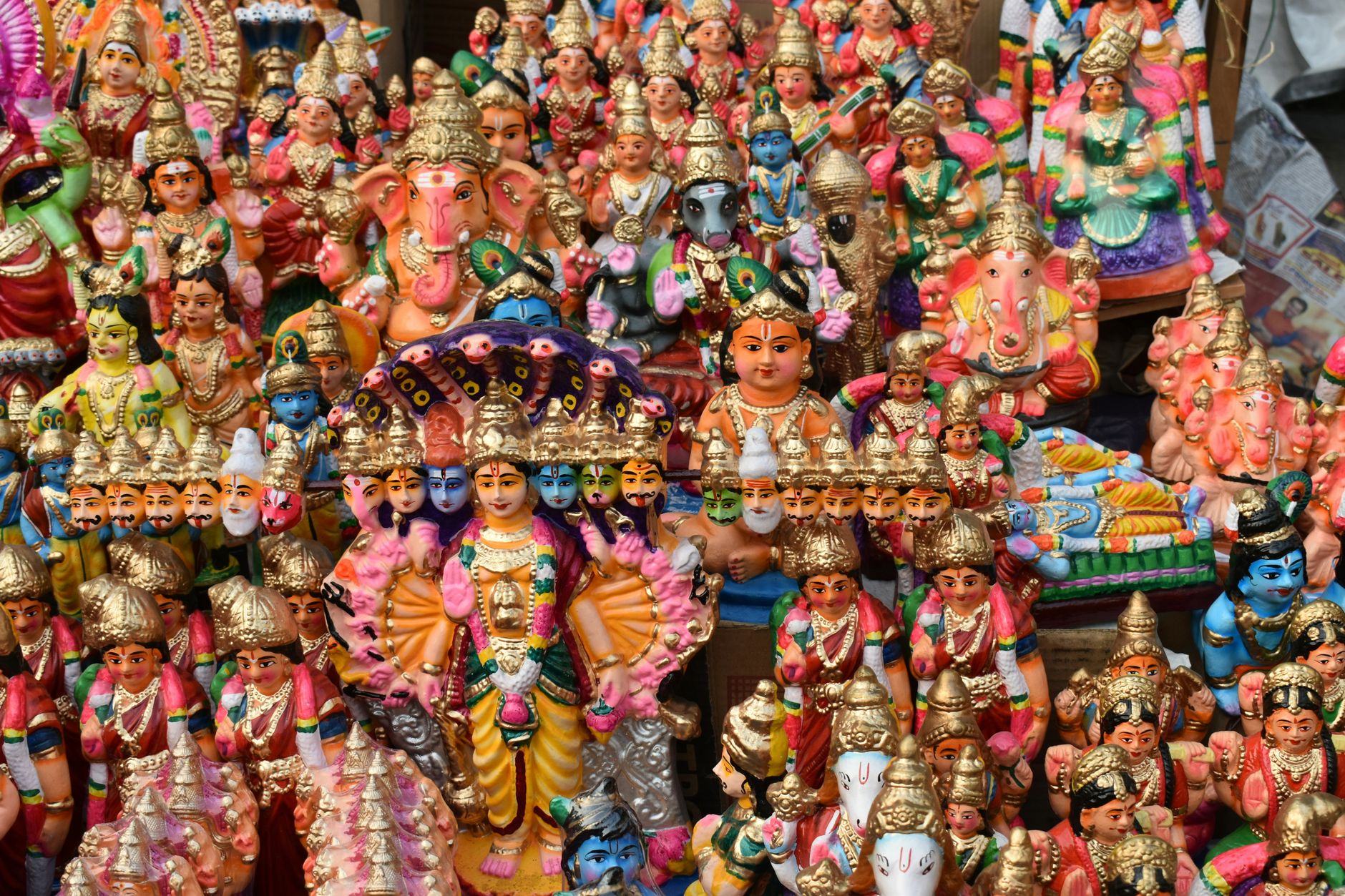 Vibrant collection of traditional Hindu deity figurines, showcasing Indian religious culture.